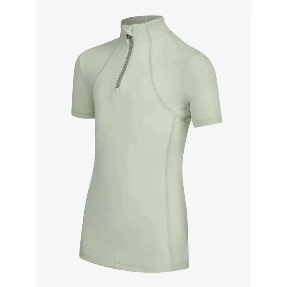 A sleek light green lemieux young rider short sleeve base layer pistachio with a high collar and silver zipper