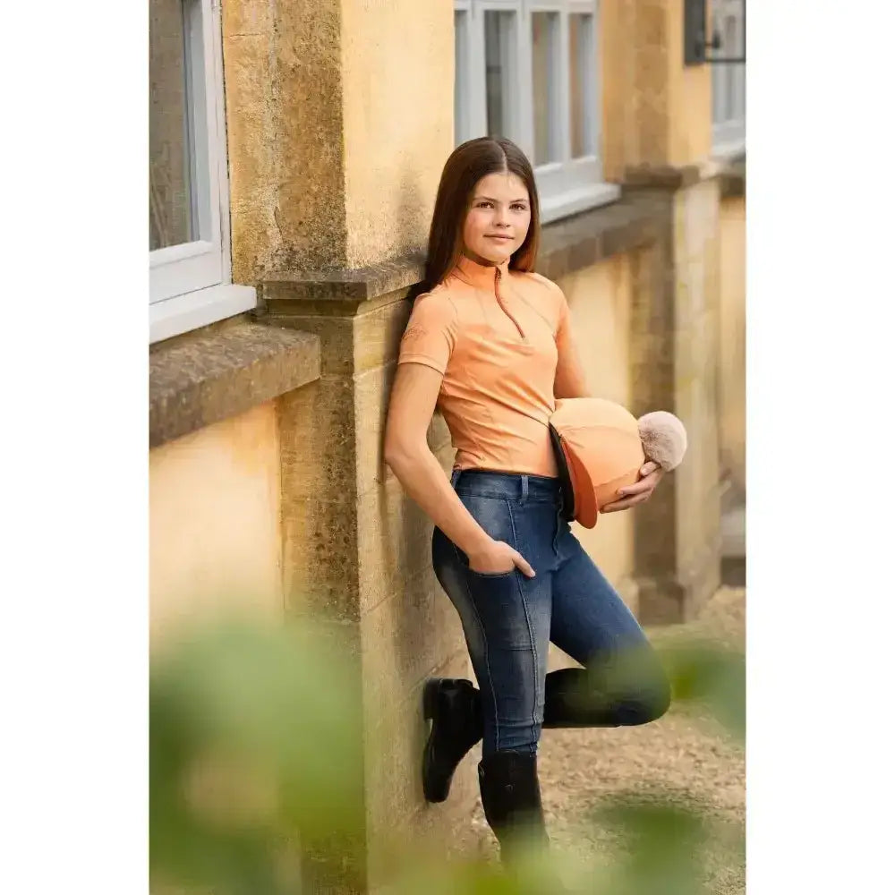 Peach-colored lemieux young rider short sleeve base layer sherbet with zipper neckline perfect for riding days