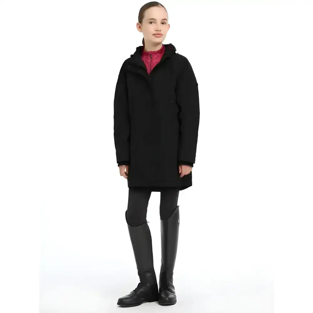 Black lemieux young rider skye waterproof coat with matte finish and subtle seam detailing in hoodie style