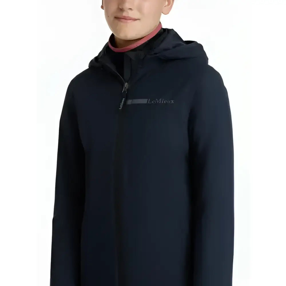 Black lemieux young rider thea water resistant jacket in navy with a subtle gray chest logo and hooded design