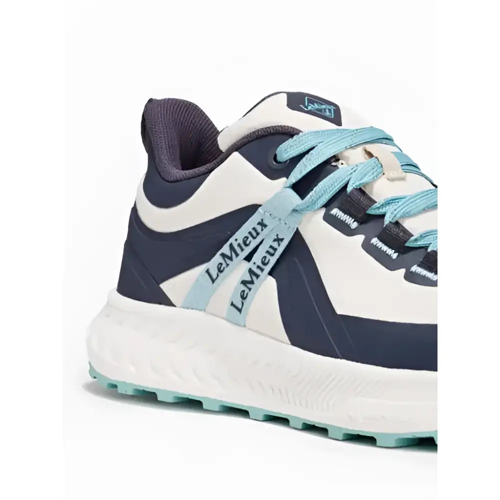 White and navy blue lemieux youth trax viva waterproof trainer with teal laces and textured rubber sole