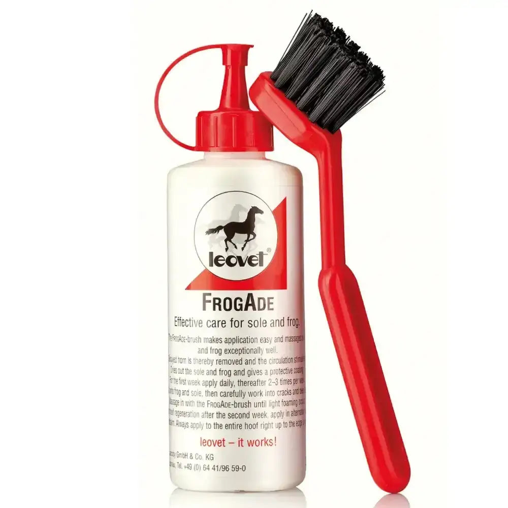 Leovet frogade c/w brush with red handle and black bristles next to white bottle for hoof problems and frog care