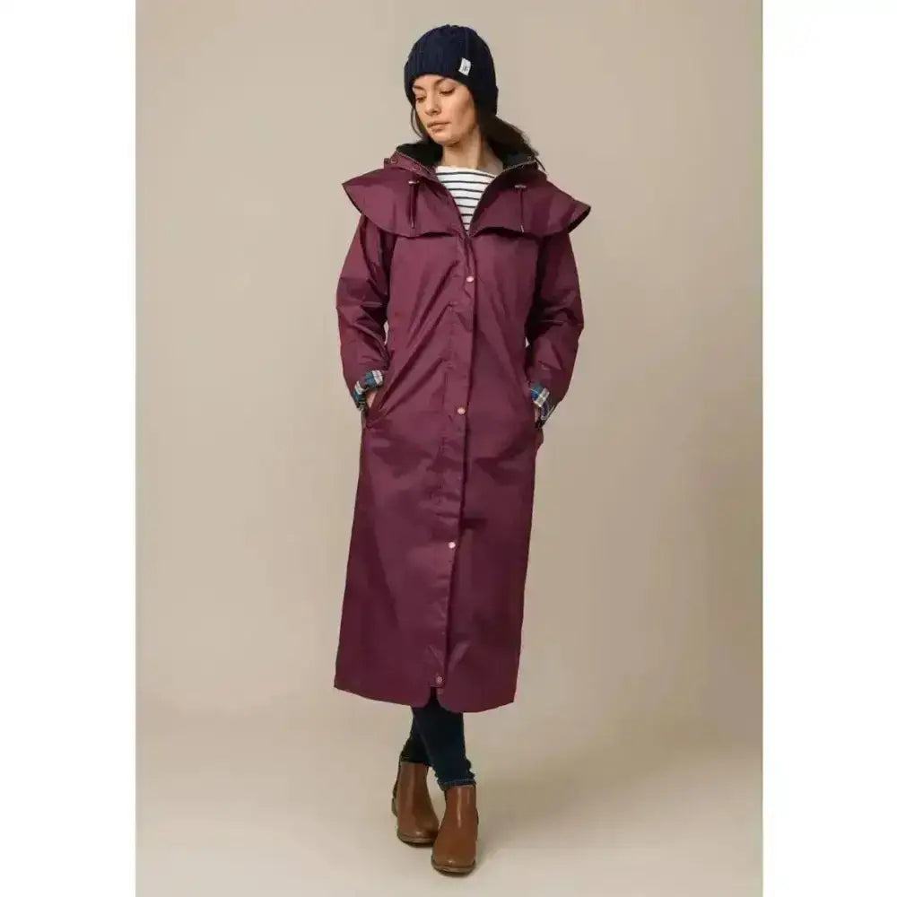 Maroon lighthouse outback ladies longline waterproof raincoat with ruffled hood and button closures and adjustable leg straps