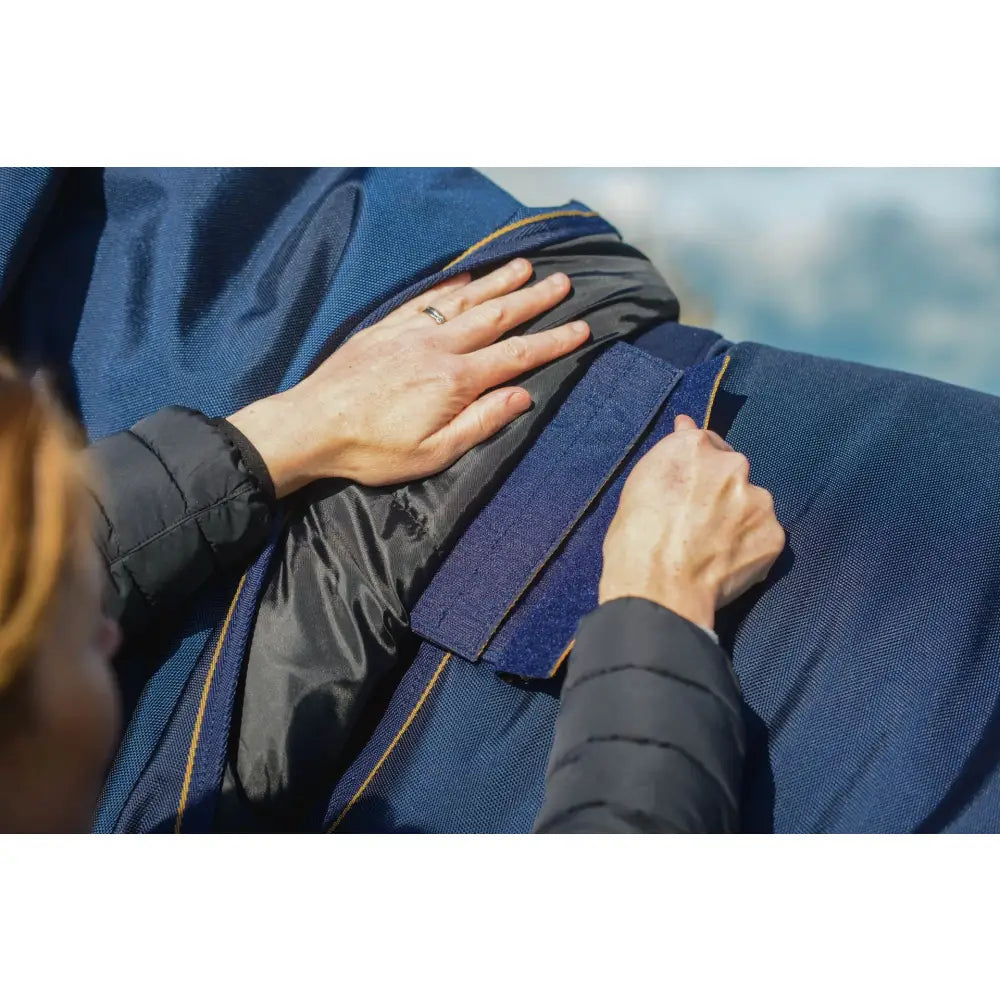 Blue nylon wicklow turnout heavy jacket with black inner lining gold zipper trim and detachable neck piece