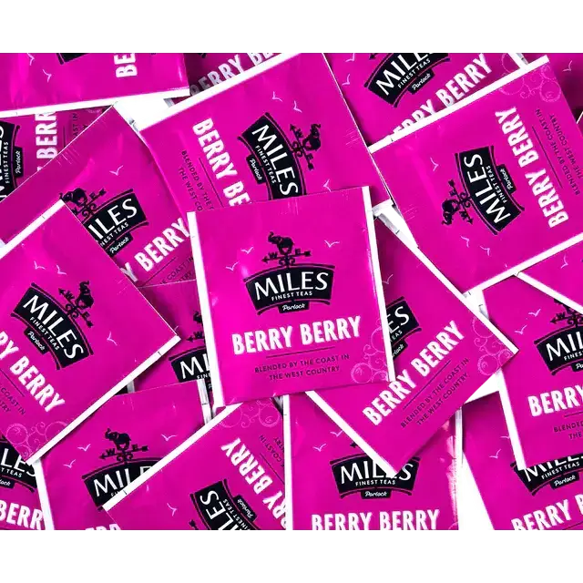 Bright pink berry envelope teabags of miles tea coffee berry flavor perfect for a fruity tea experience