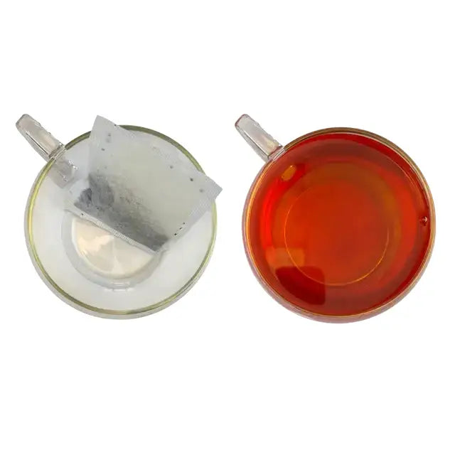 A clear glass tea cup with brewed earl grey tea made from miles tea earl teabags with italian bergamot oil