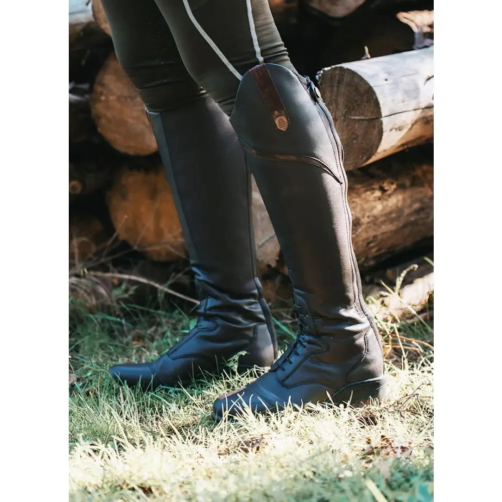 Black leather mountain horse veganza tall riding boot with side zipper and brown patch near the top