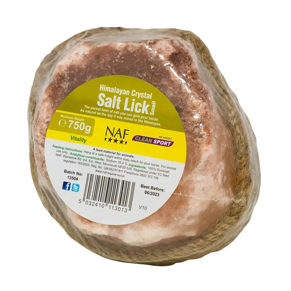 A pink himalayan salt lick wrapped in clear plastic with a yellow and white naf himalayan salt label