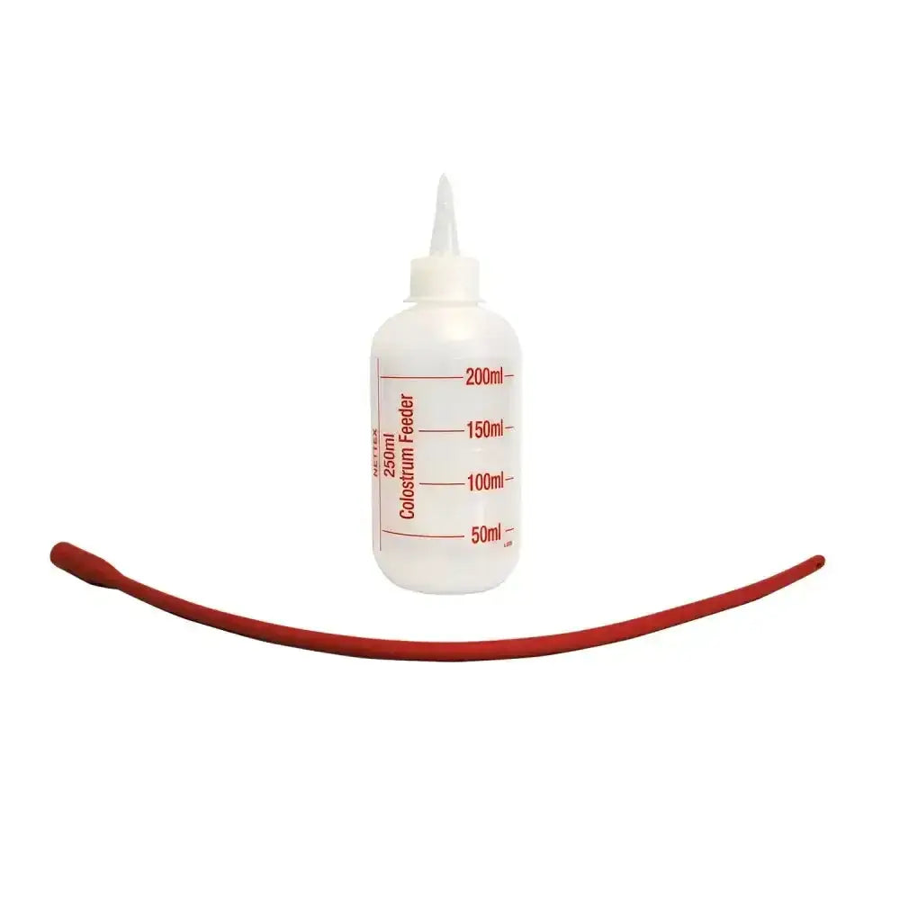 White plastic nettex agri colostrum feeder bottle with red measurement markings and curved red latex tube