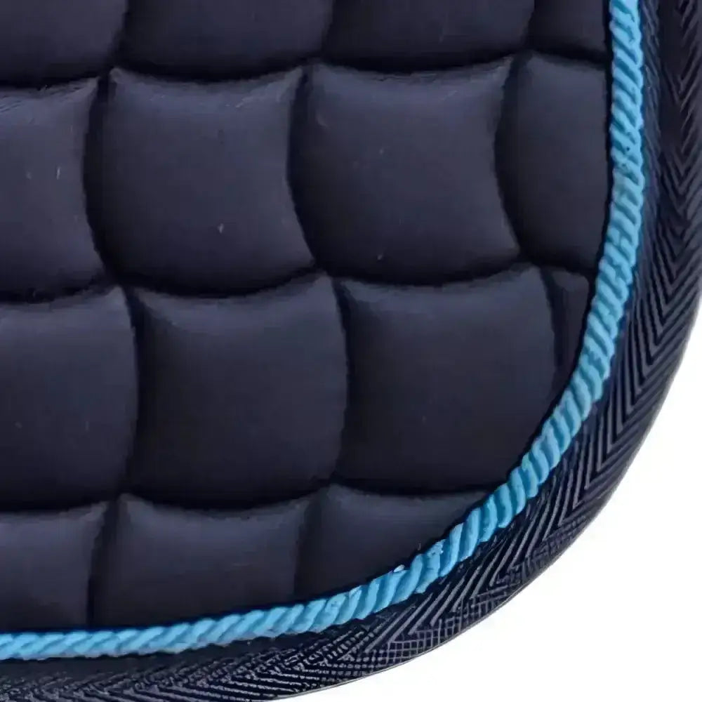 New gallop dressage saddle pad in dark navy quilted fabric with bright blue braided edge and contoured spine design