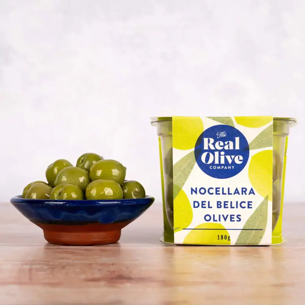 A vibrant yellow and green tin of nocellara del belice stuffed green olives from the real olive company 180g