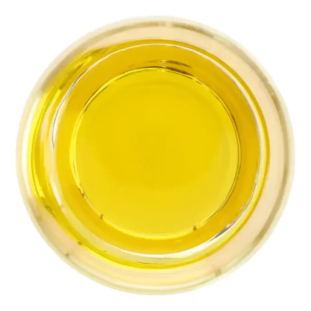 Clear glass bowl filled with golden yellow omega equine ultra oil made from sea buckthorn oil for horses