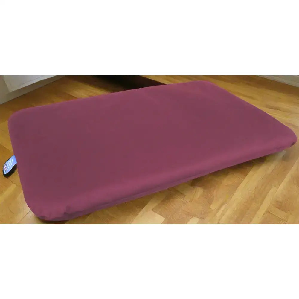 A plush purple p&l country dog heavy duty waterproof duvet dog bed cushion on a wooden floor