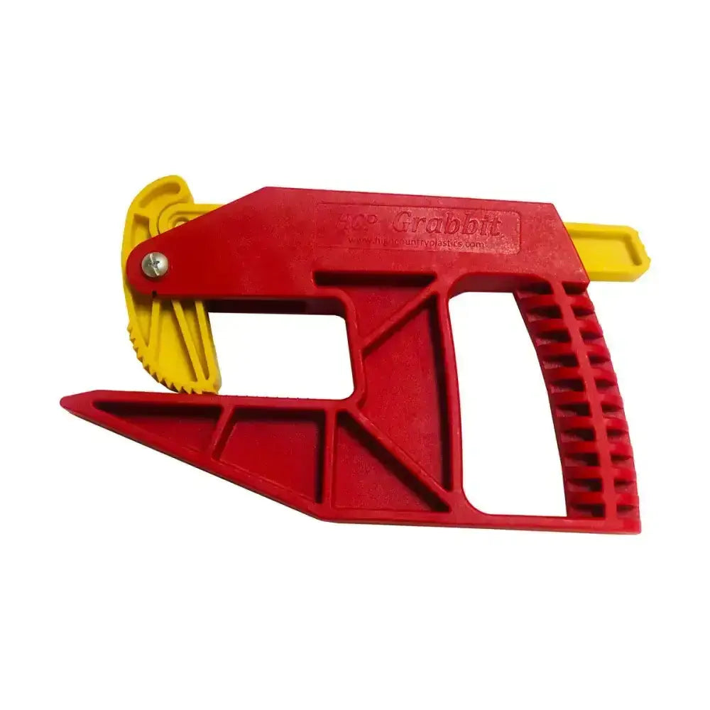 Red and yellow plastic parallax grabbit tool with serrated cutting edge for precise cuts in stable accessories setup
