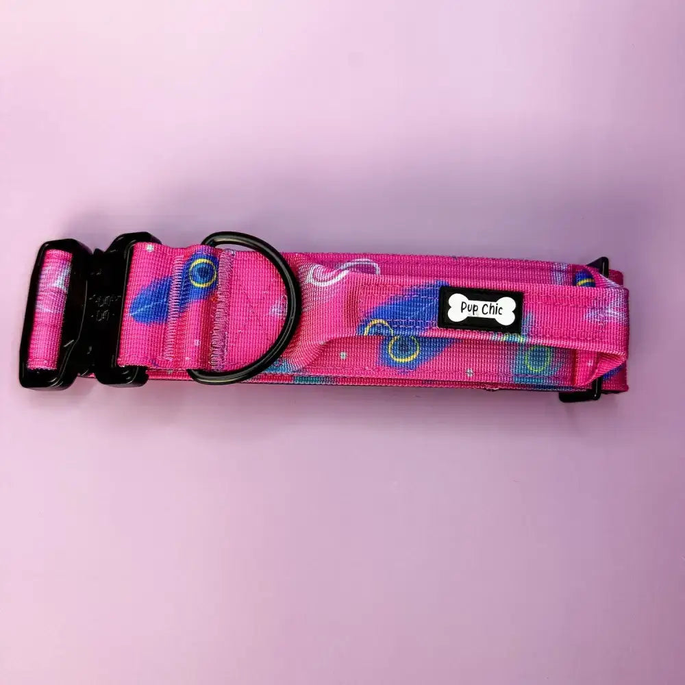 Peacock power dog collar with pink cosmic blue yellow swirls and black plastic hardware for tiny puppies