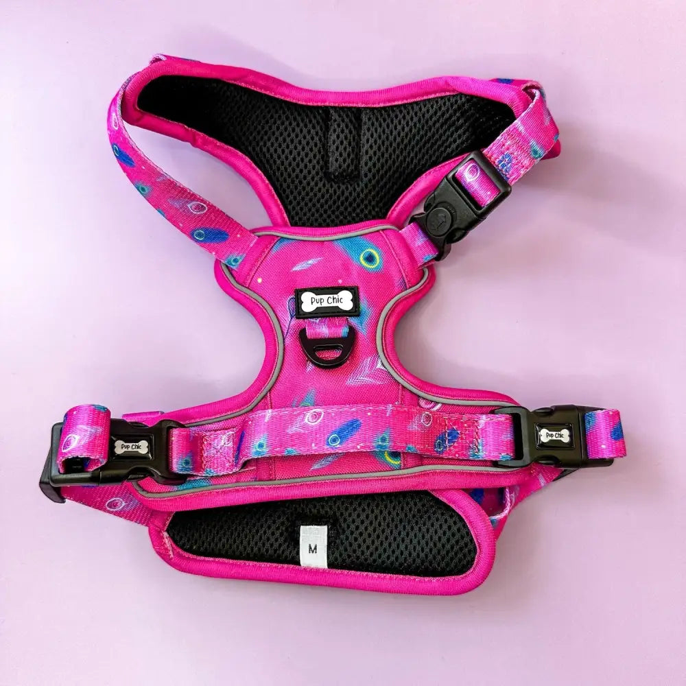 Pink tactical dog harness with peacock feather print black mesh padding adjustable straps and pup chic label