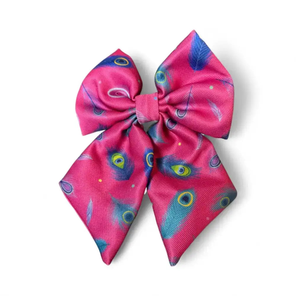 Vibrant pink satin peacock power sailor bow with bold beautiful peacock feather pattern and secure elastic loops