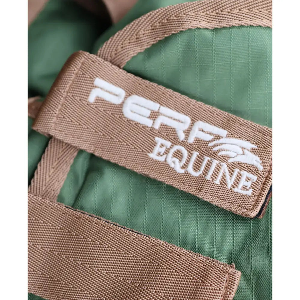 Tan woven strap with white perf equine logo and horse emblem on green quilted fabric of perf combo 0g lightweight turnout rug