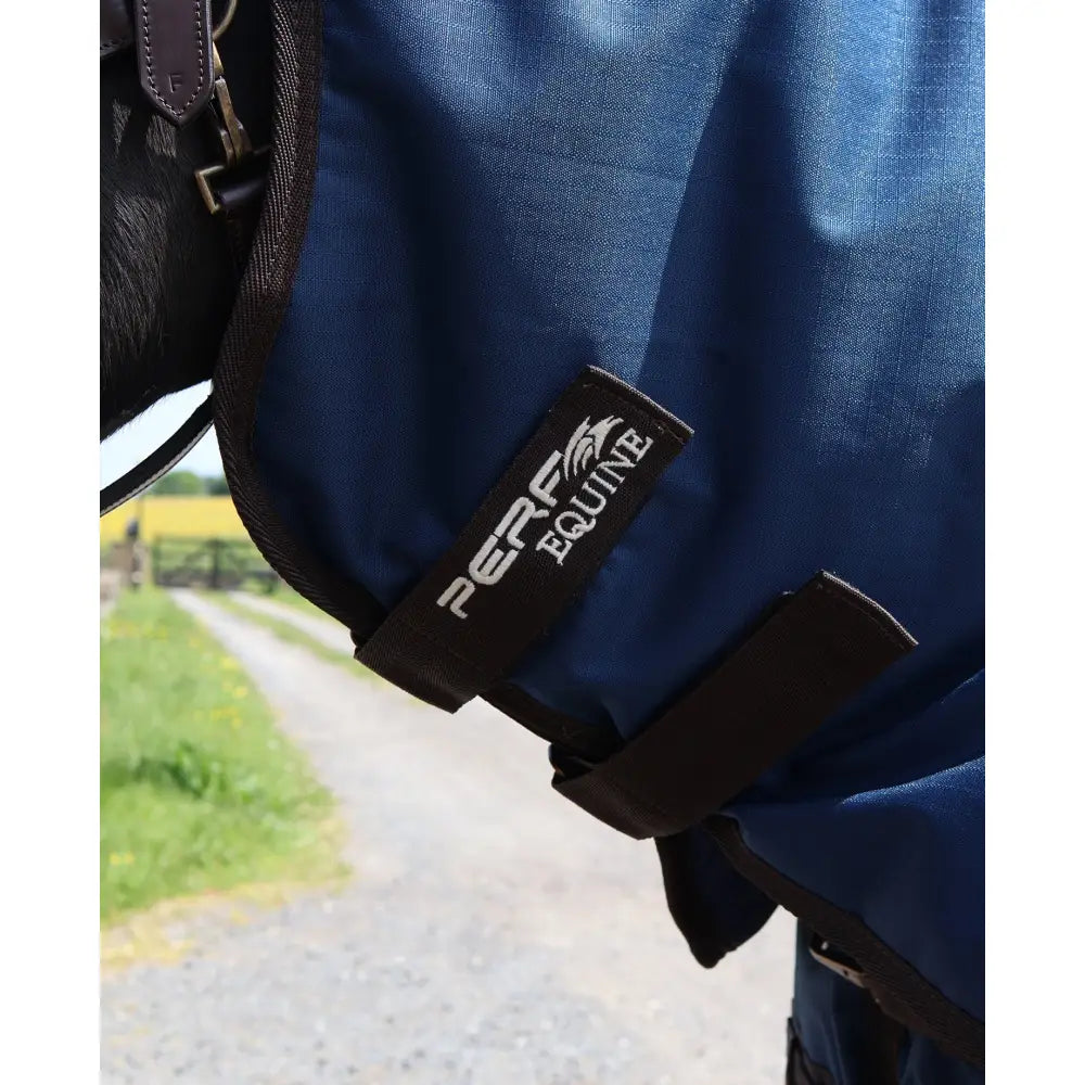 Blue perf turnout rug with black straps and branded label featuring a perf detachable neck for horses