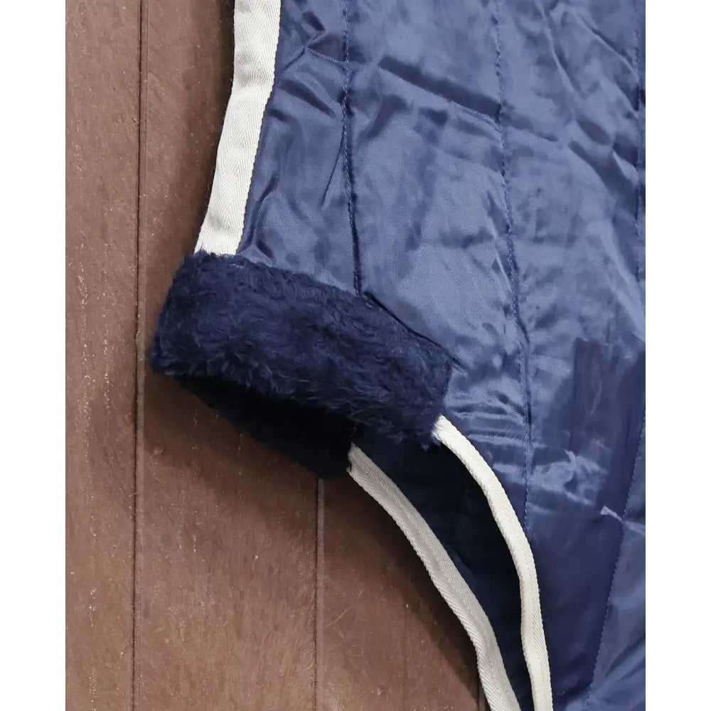 Navy blue perf standard 100g quilted stable rug with white piping and fleece-lined hem perfect for light weight use