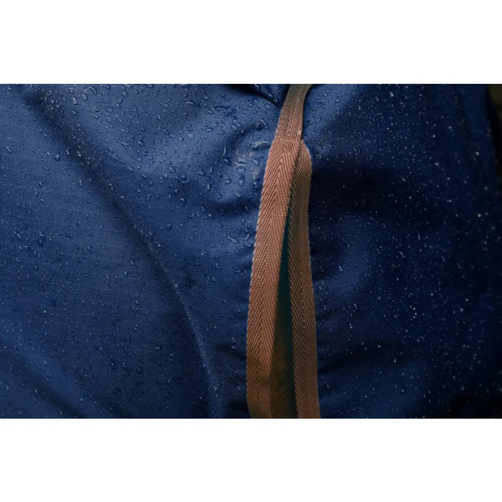 Dark blue water-resistant perf standard 100g lightweight turnout rug with brown herringbone strap for horses