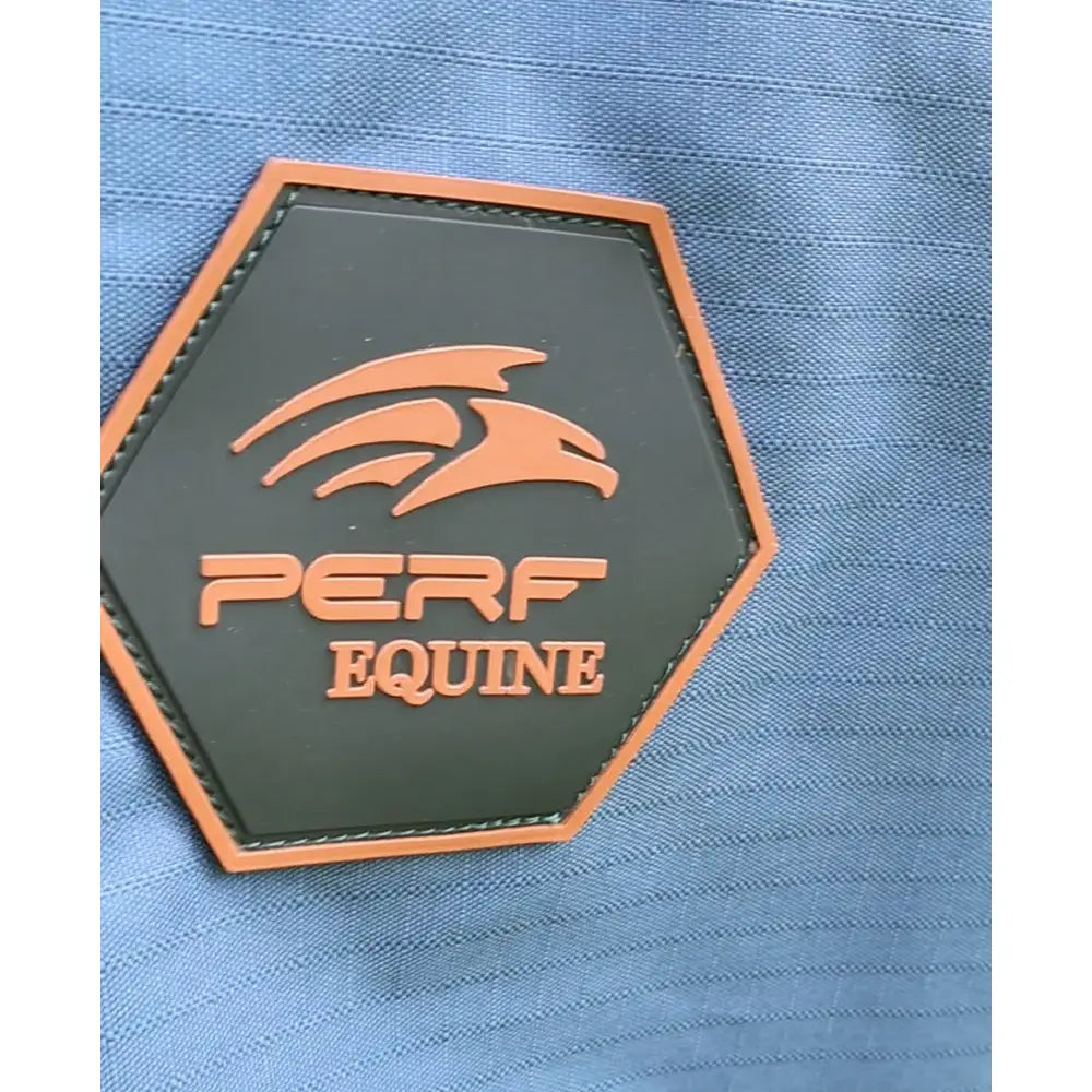 Orange and black hexagonal patch with eagle logo and perf equine text stitched on blue perf standard 50g turnout rug