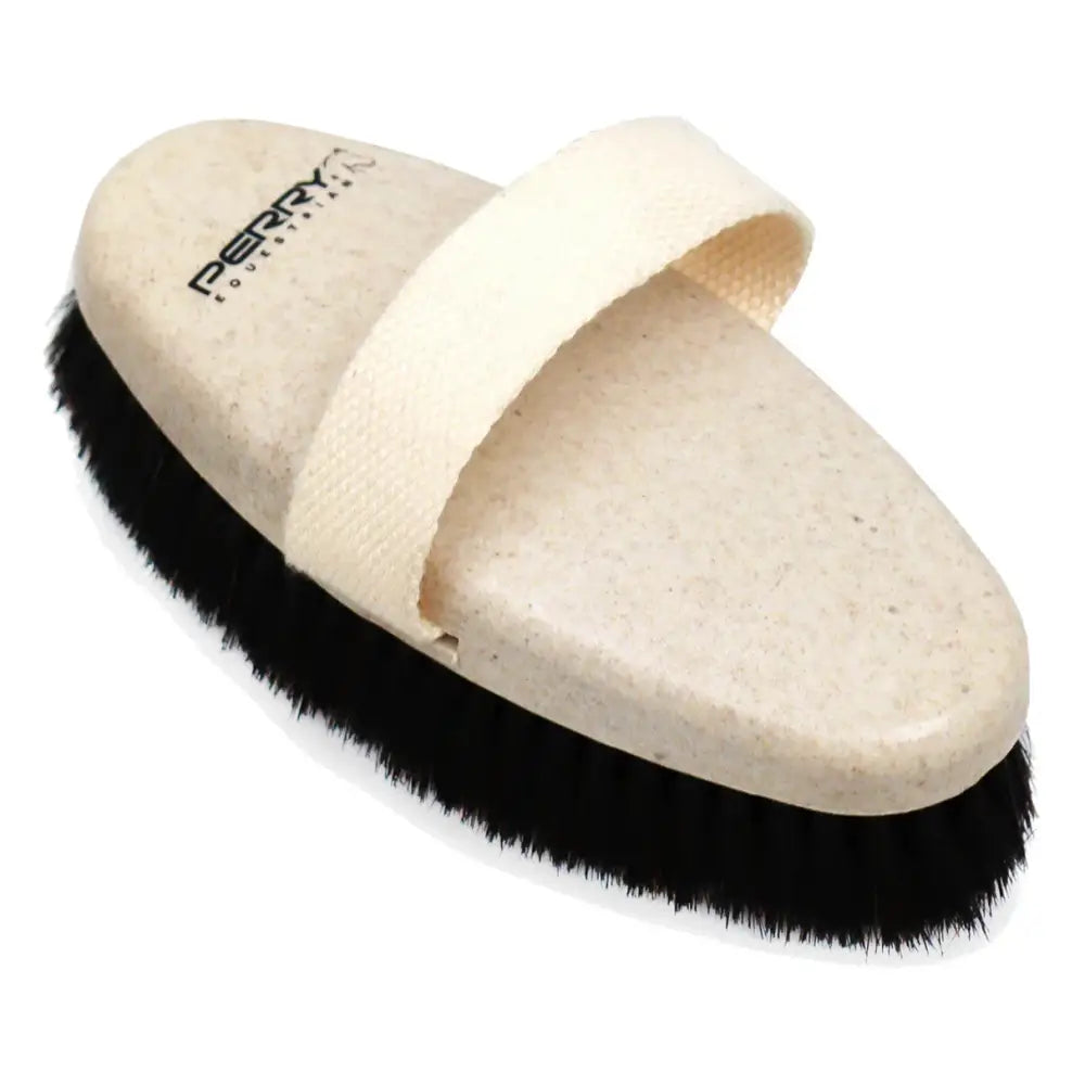 Beige oval-shaped body brush with black bristles and strap perry ellis perry equestrian ecogroom body brush model 7231