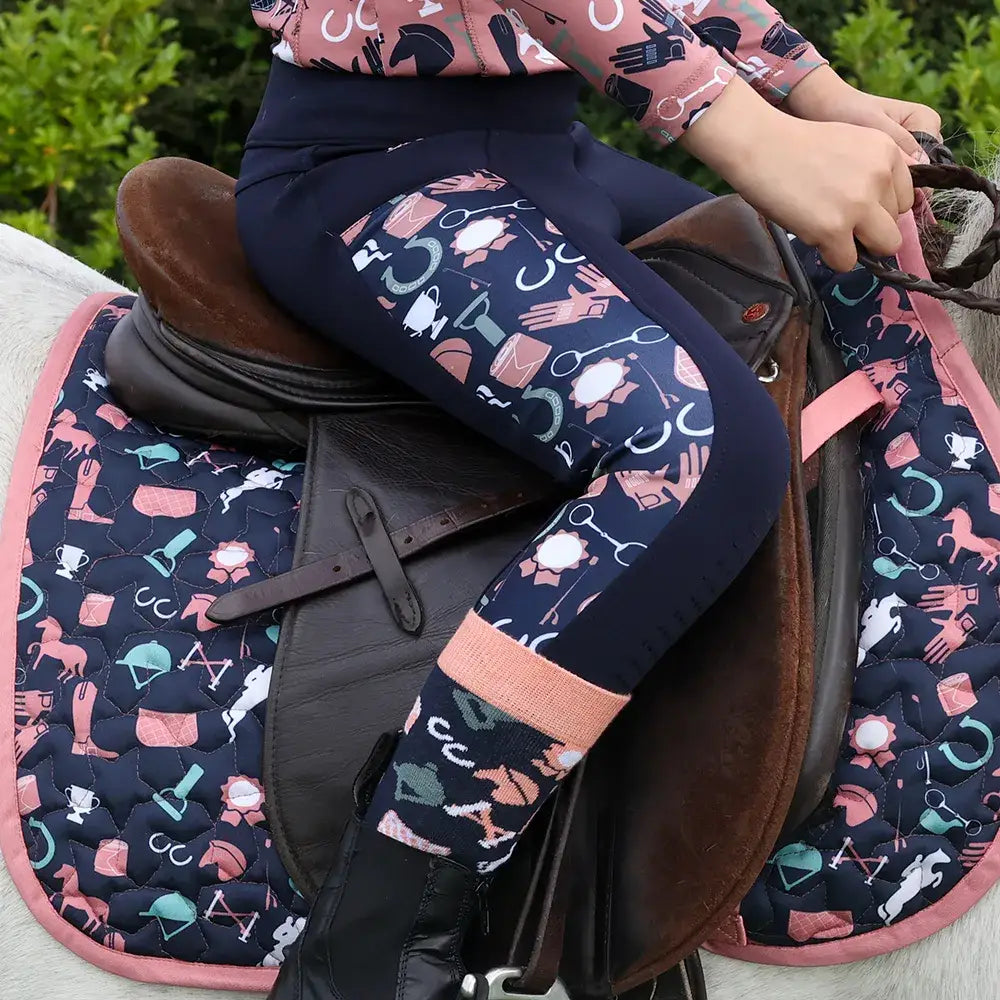 Navy riding tights with playful pink white and teal horse gear icons featuring passion print panels pony passion riding