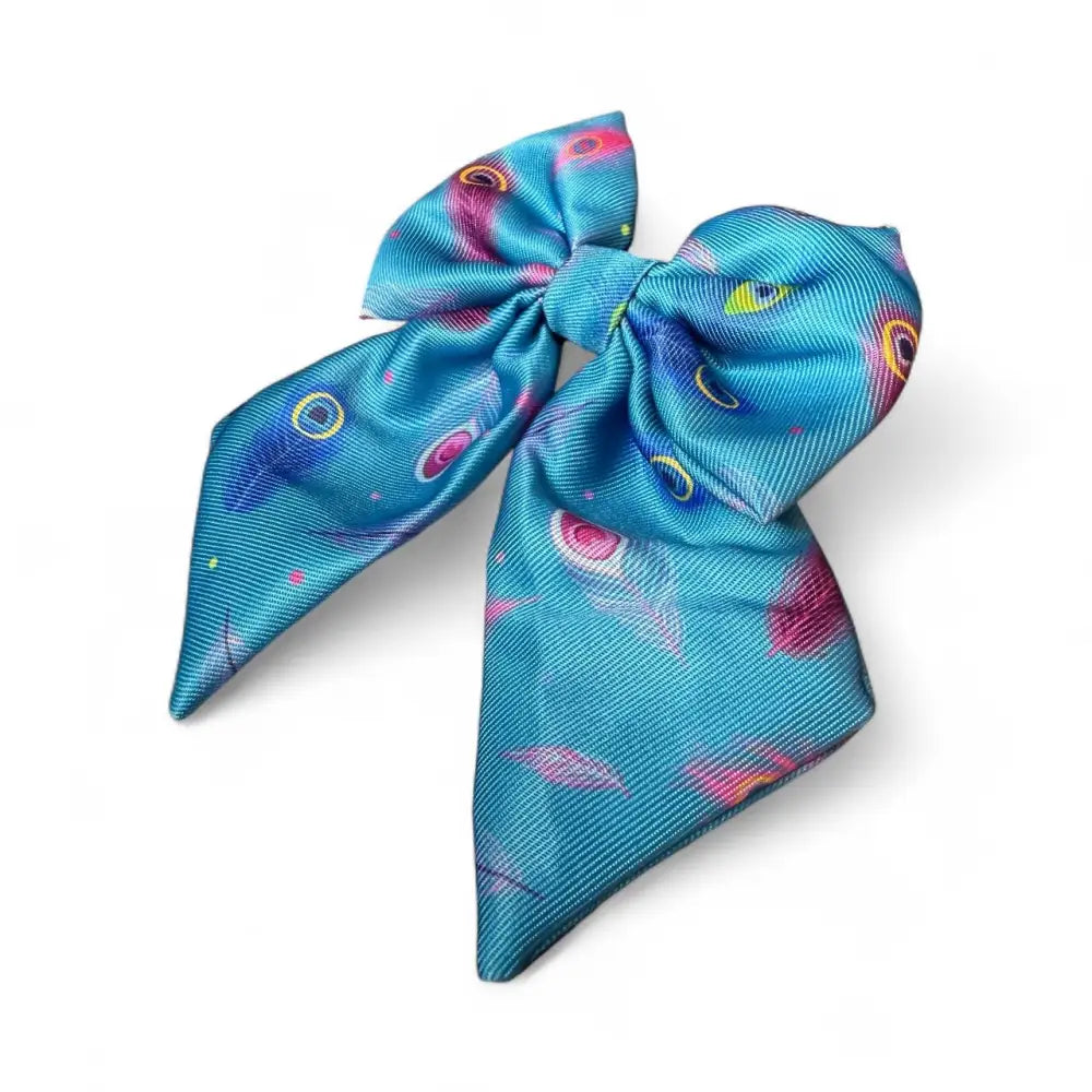 A vibrant turquoise satin power peacock collection sailor bow with playful teal feather pattern for dress-up days