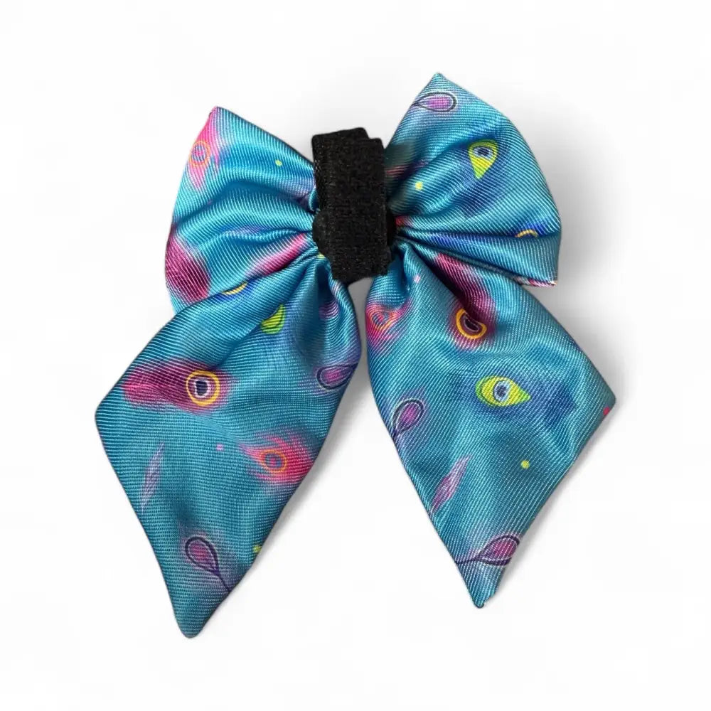 A vibrant blue satin peacock sailor bow from the power peacock collection with colorful eyes and swirls, perfect for dress-up days