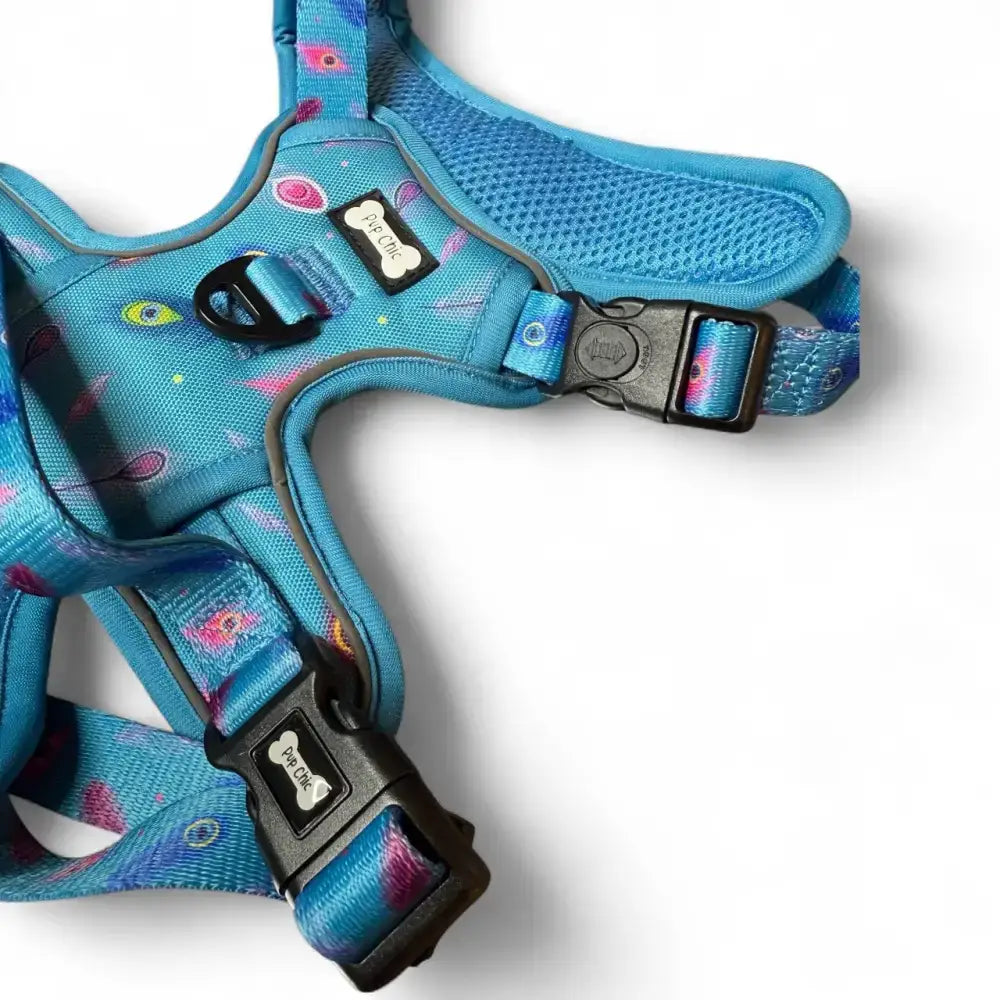 Power peacock tactical dog harness in vibrant blue with colorful eye pattern, fully adjustable and padded for comfort