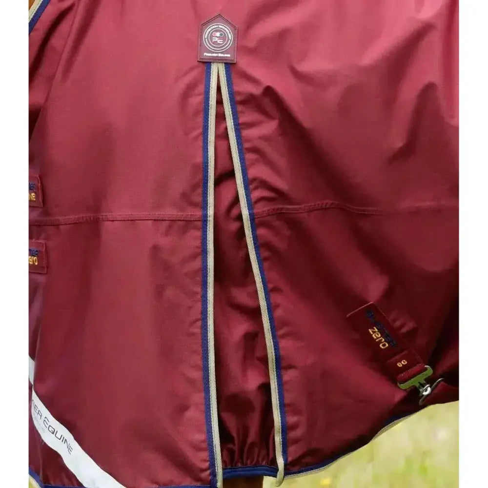 Maroon premier equine buster turnout rug with blue and white trim made from durable denier ballistic nylon