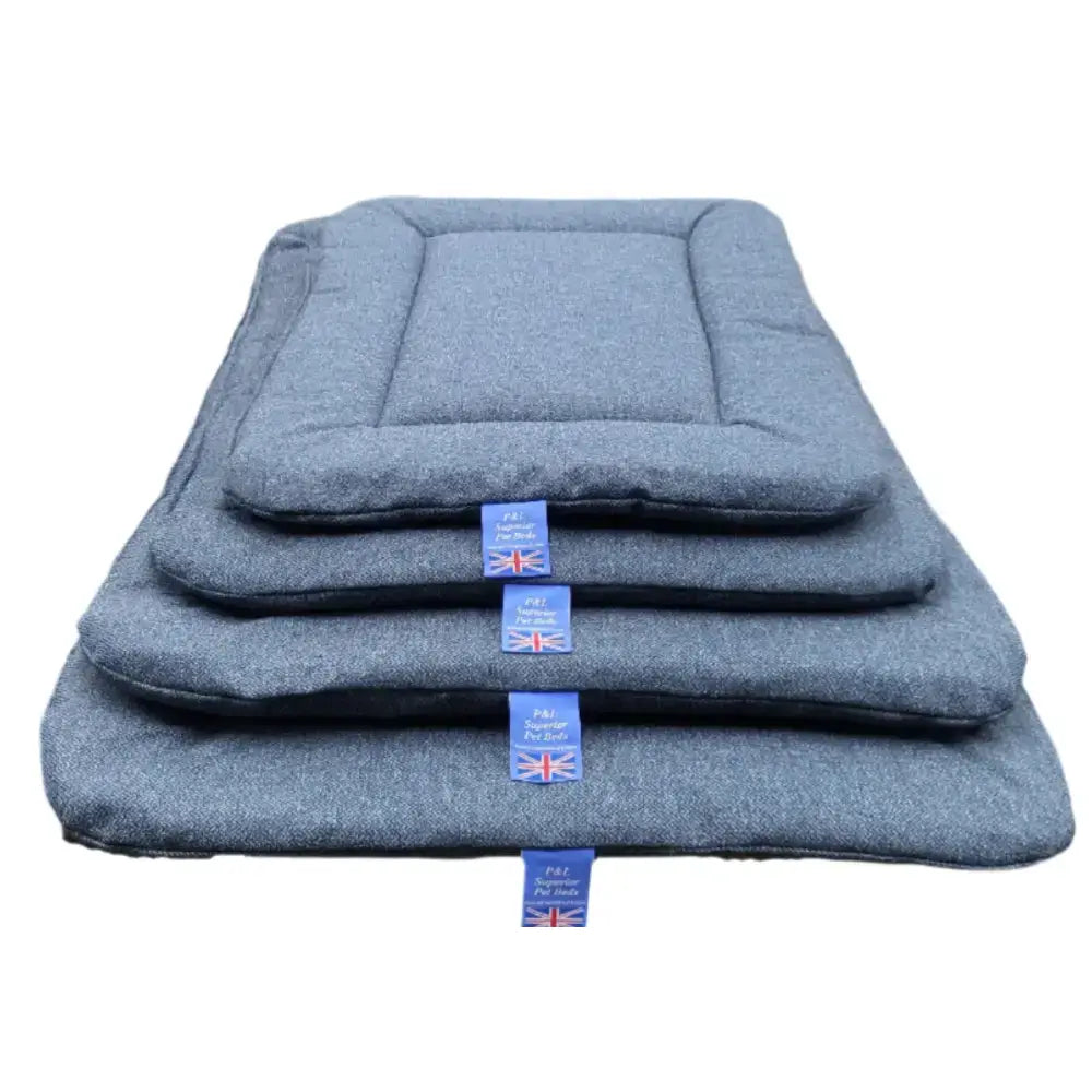 Stacked gray woolen premium orkney tweed rectangular pads with stitched edges and blue brand tags by p&l country dog beds