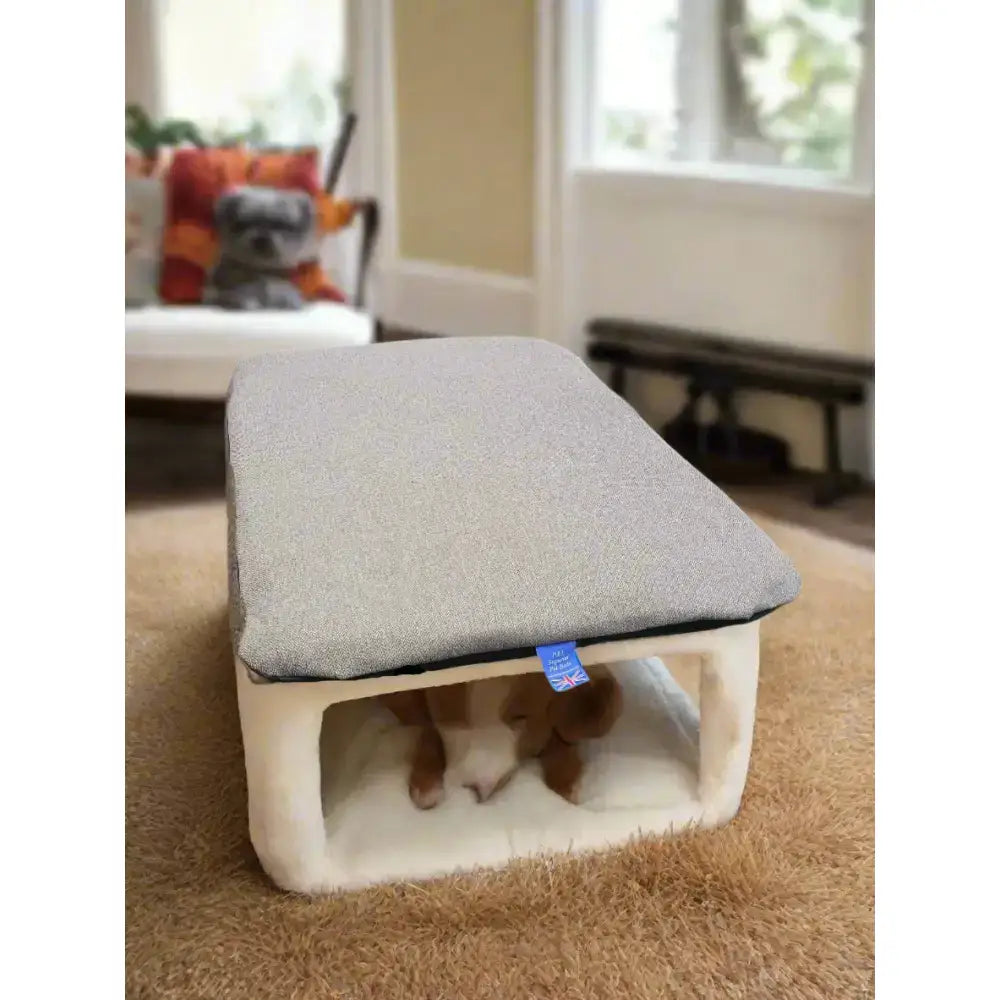 Gray upholstered pet bed with cream waterproof base and small blue tag featuring premium orkney tweed removable cover duvet