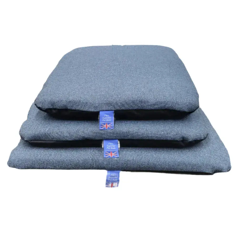 Stacked gray woolen pet beds with blue tags featuring premium orkney tweed removable cover duvet design