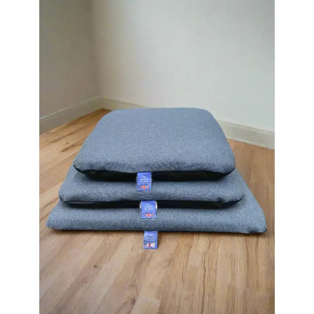 Stacked gray woolen dog mats with blue brand tags for premium orkney tweed removable cover duvet with waterproof base