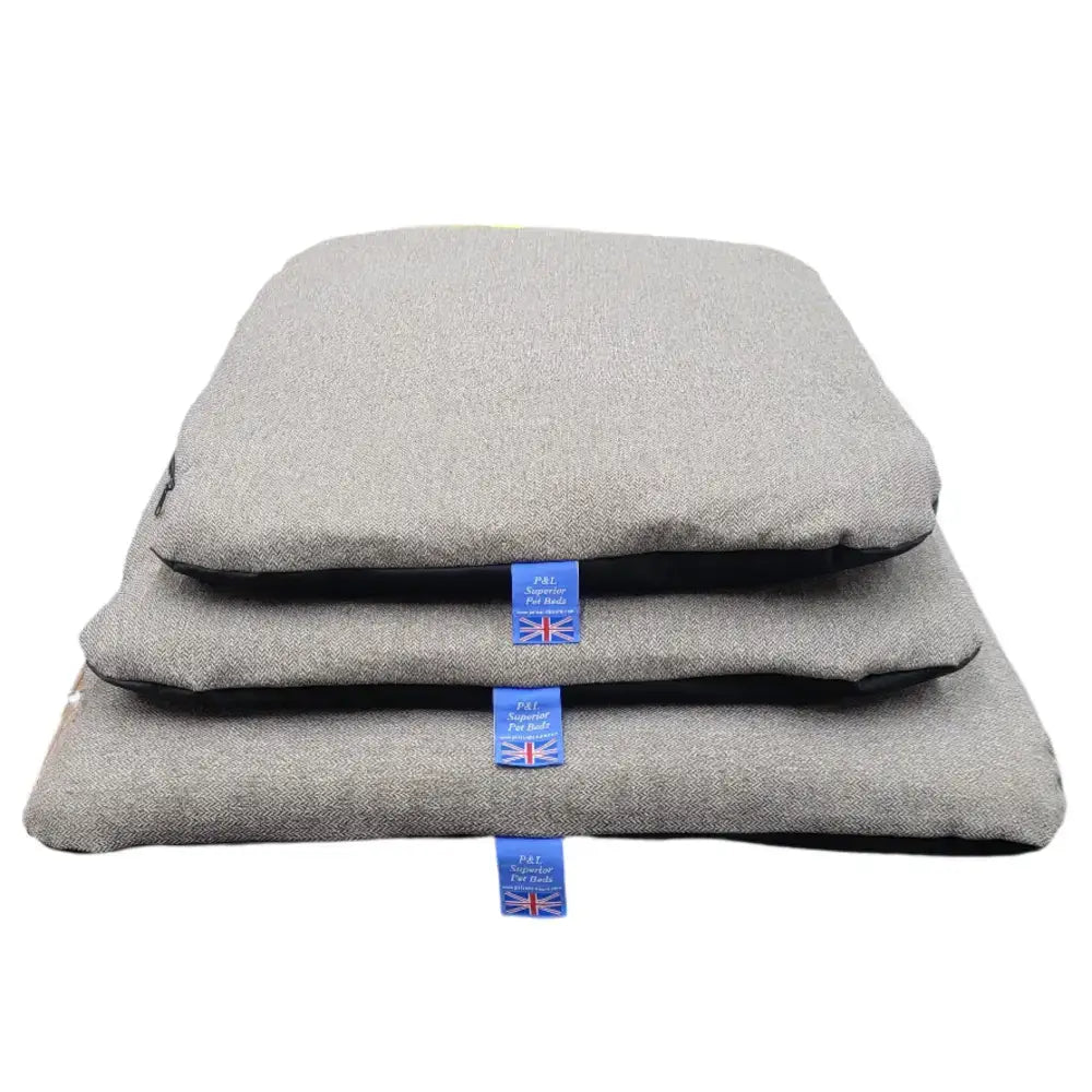 Stacked gray premium orkney tweed pet beds with black trim removable cover duvet and blue brand tags