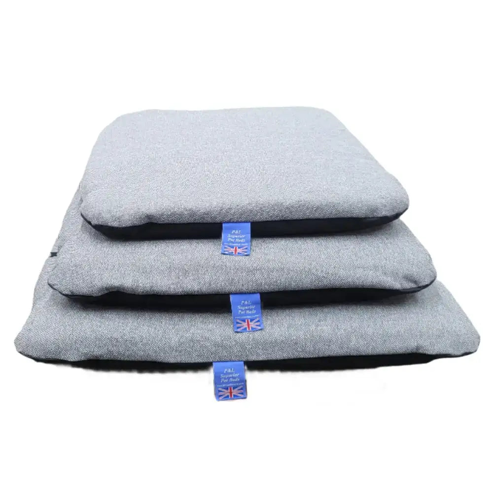 Stacked gray pet beds with black lining and blue tags featuring premium orkney tweed removable cover duvet design