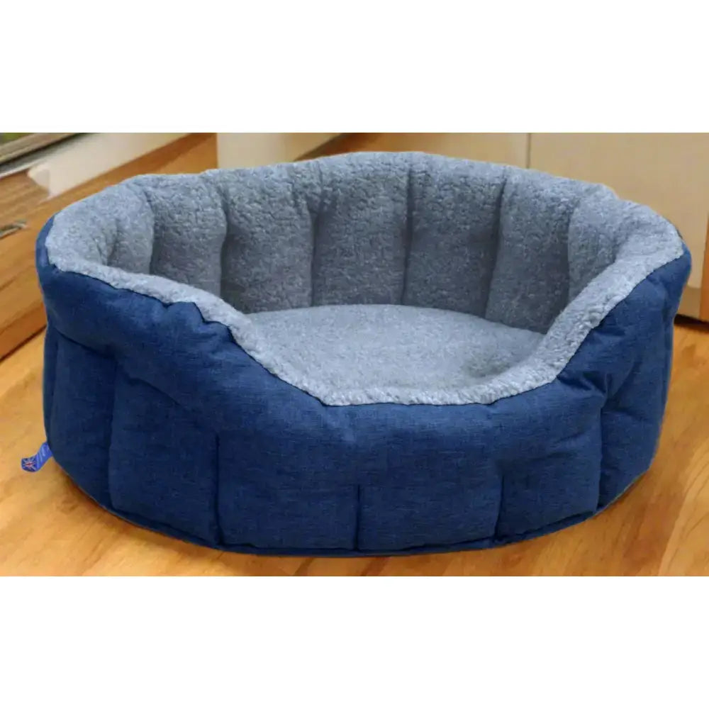 Blue plush premium oval bolster dog bed with heavy duty fleece lined quilted exterior and machine washable design