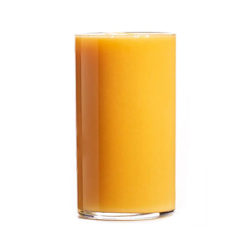 A tall clear glass filled with vibrant orange projuice passion storm juice perfect after a barnstaple equestrian ride