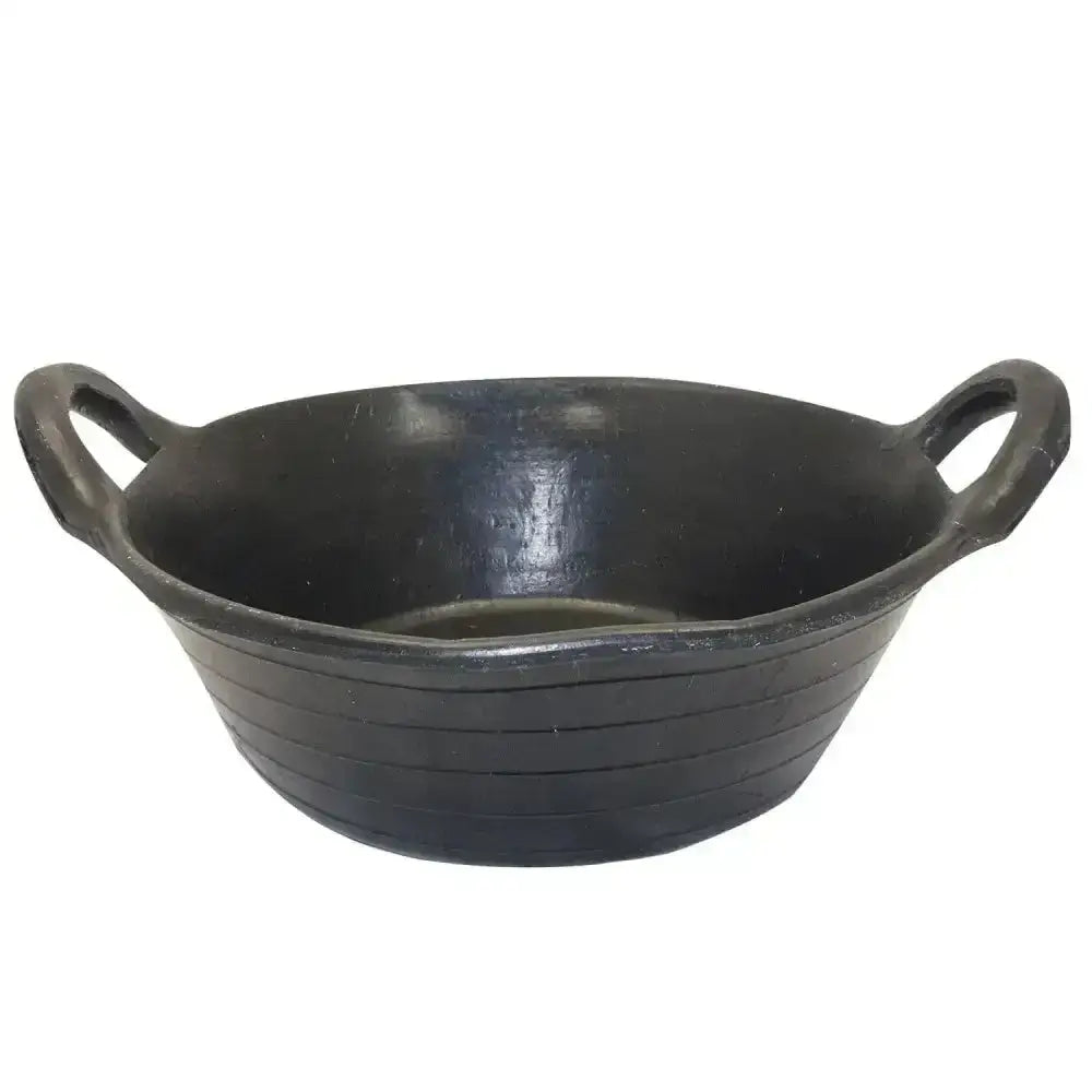 Black oval-shaped cast iron prostable feed skip with two looped handles and horizontal ridges for flexible feed use