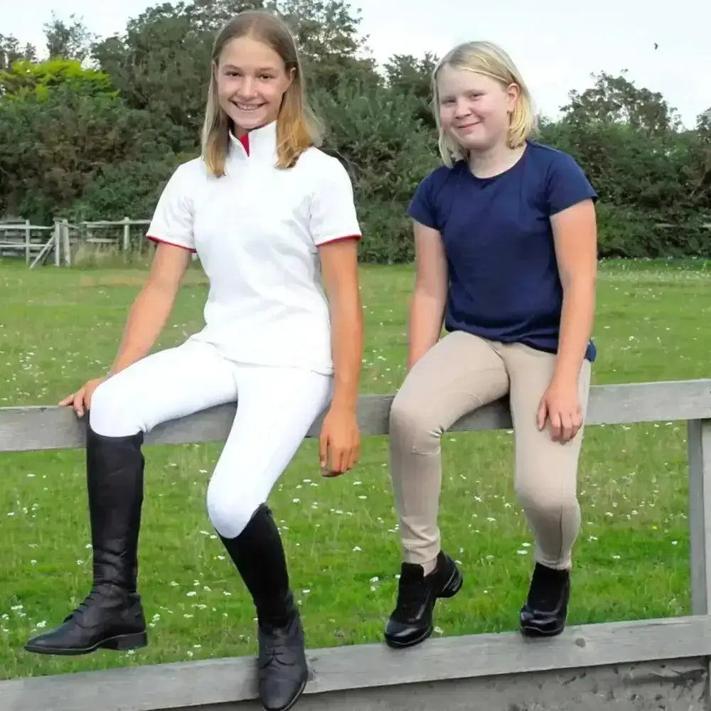 White riding boots with black leather uppers and laced detailing from rhinegold childs jodhpurs essential everyday collection