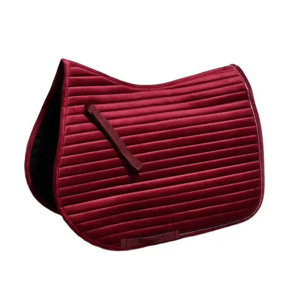 A deep red luxury velvet saddle pad with ribbed texture and black lining rhinegold diamante channel quilt design