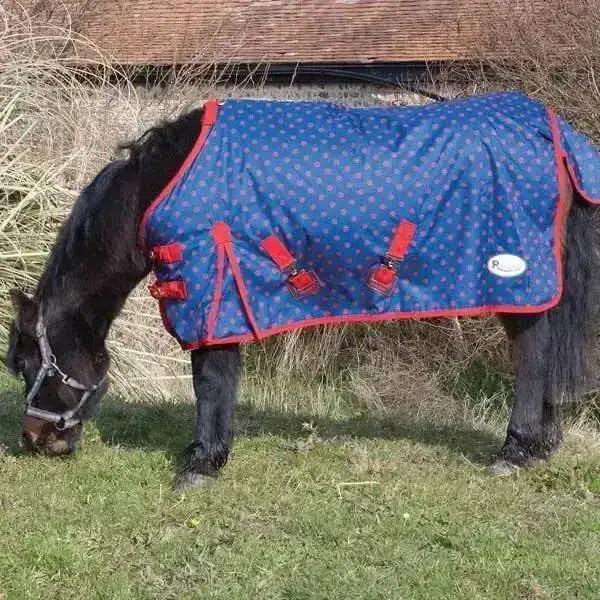 Blue polka-dotted rhinegold dottie torrent lightweight turnout rug with red trim waterproof breathable outer for foals