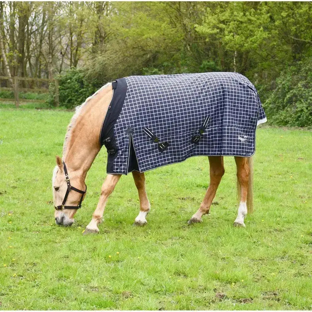 Navy blue and white checkered rhinegold elite montpelier turnout rug with black trim and adjustable straps for horses