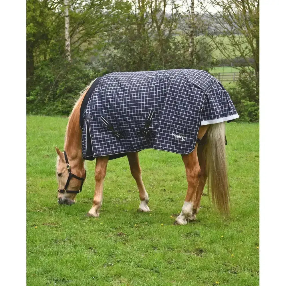 Navy blue and white checkered rhinegold elite montpelier turnout rug with black straps and logo for medium weight use