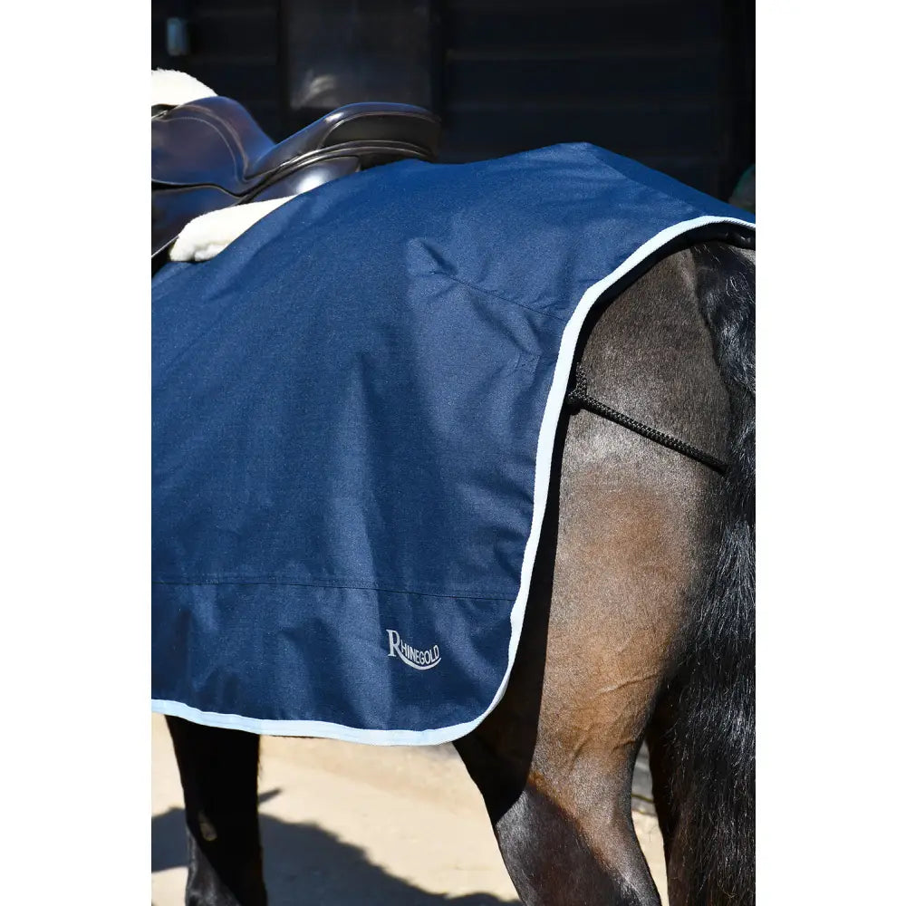 Navy blue rhinegold fixed chest waterproof horse blanket with white trim and subtle logo on lower left corner