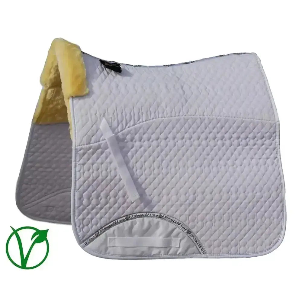 White quilted dressage saddle cloth with yellow fleece lining and rhinegold luxe fur branding on gray underside