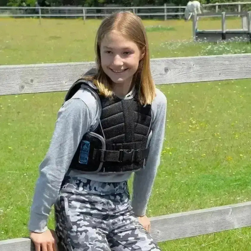 Black padded childs body protector beta with adjustable straps and blue logo patch from rhinegold pro comfort