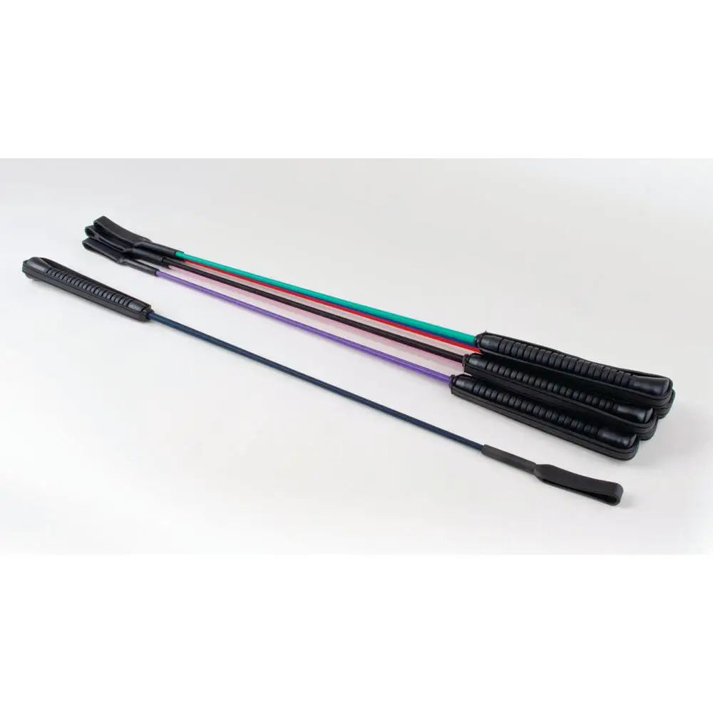 Set of four colorful rhinegold riding crop whips with black textured handles and rubberized grips for riding use